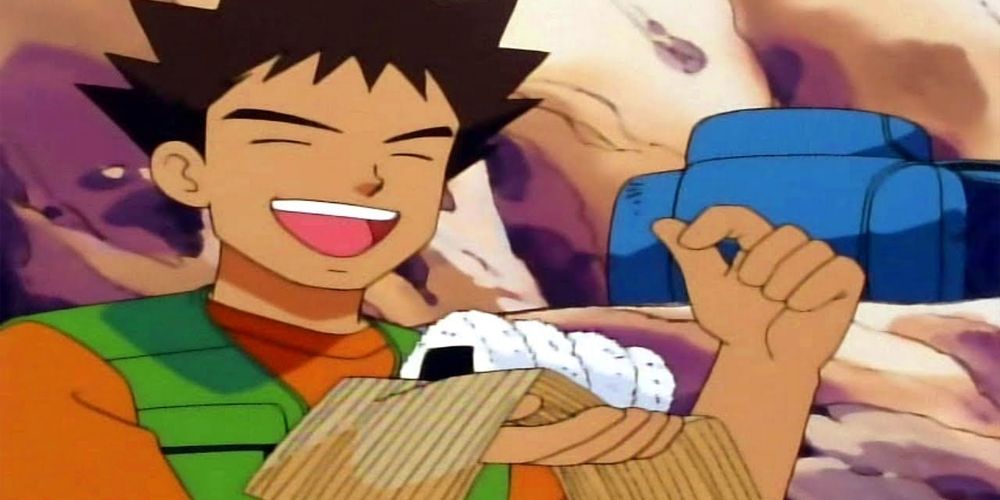 Brock from Pokémon eating rice balls.