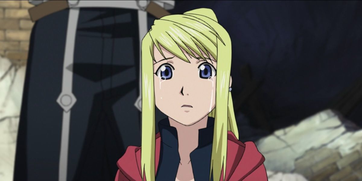 Winry crying with Edward’s cloak around her shoulders from Fullmetal Alchemist