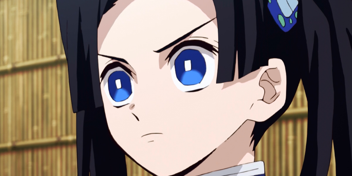 Aoi Kanzaki in Demon Slayer with blue eyes and a furrowed brow.