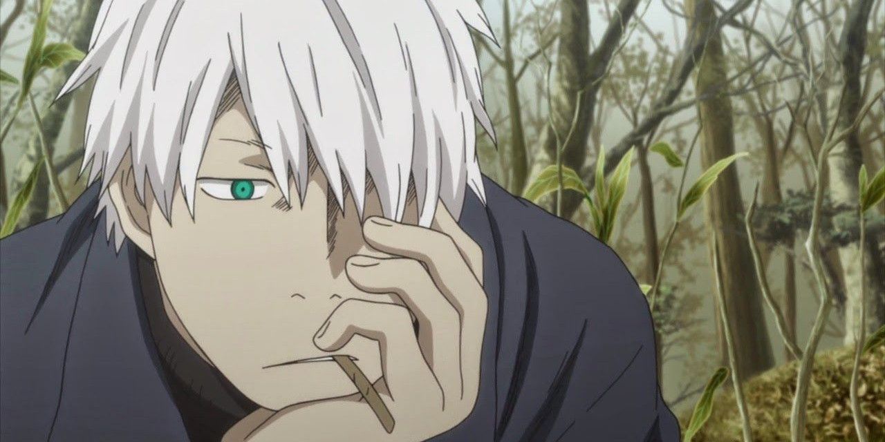 Ginko of Mushishi with his hand on his face in a forest