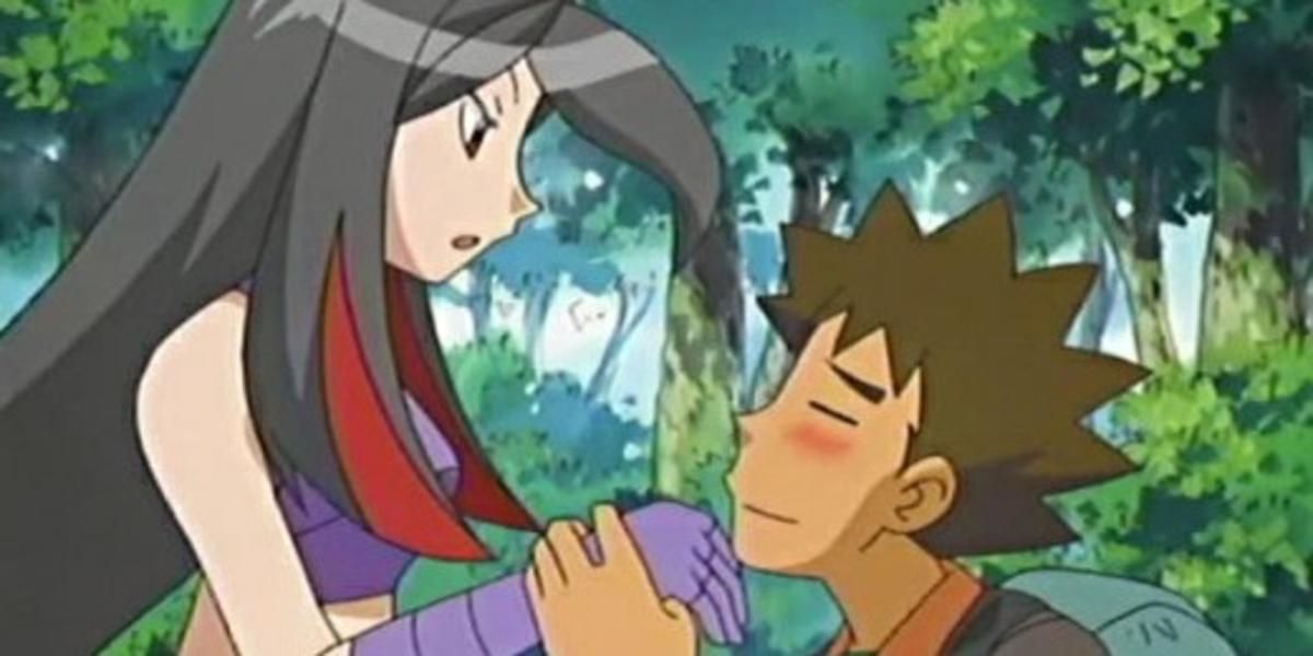 Brock kneeling down and holding Lucy's hands in Pokémon.