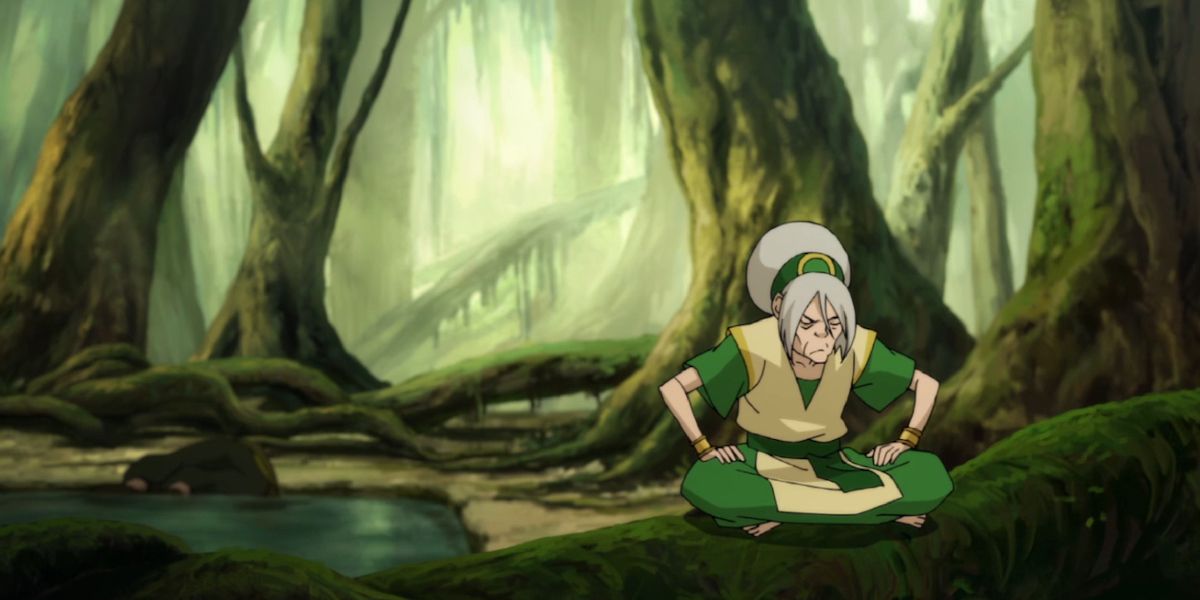 Toph sitting in a swamp