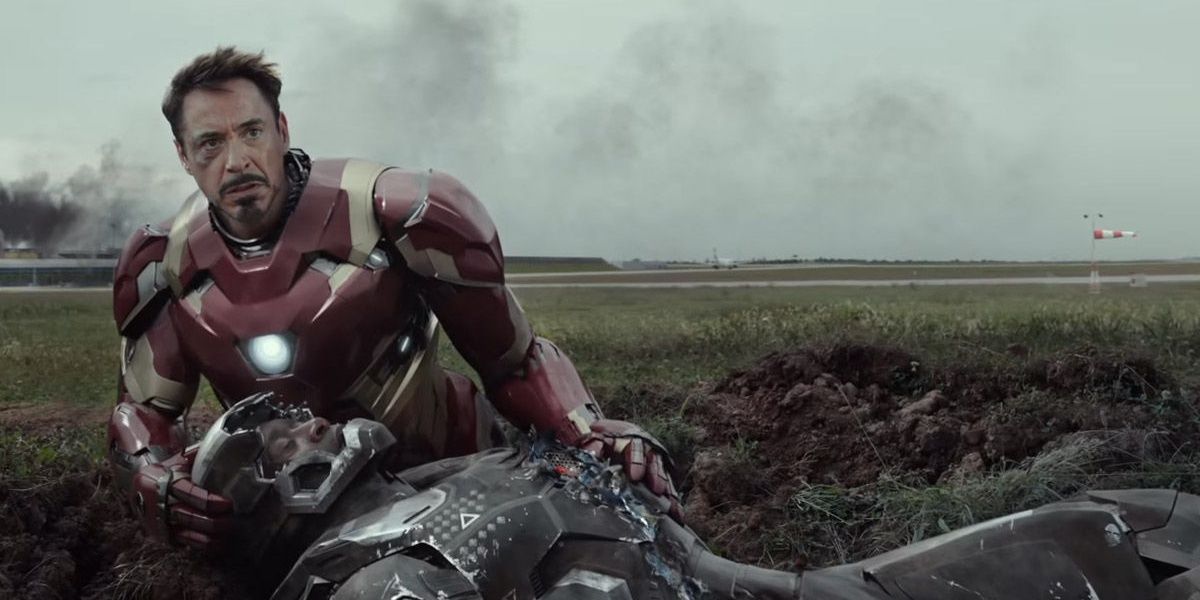 Iron Man holds an injured War Machine in Captain America: Civil War