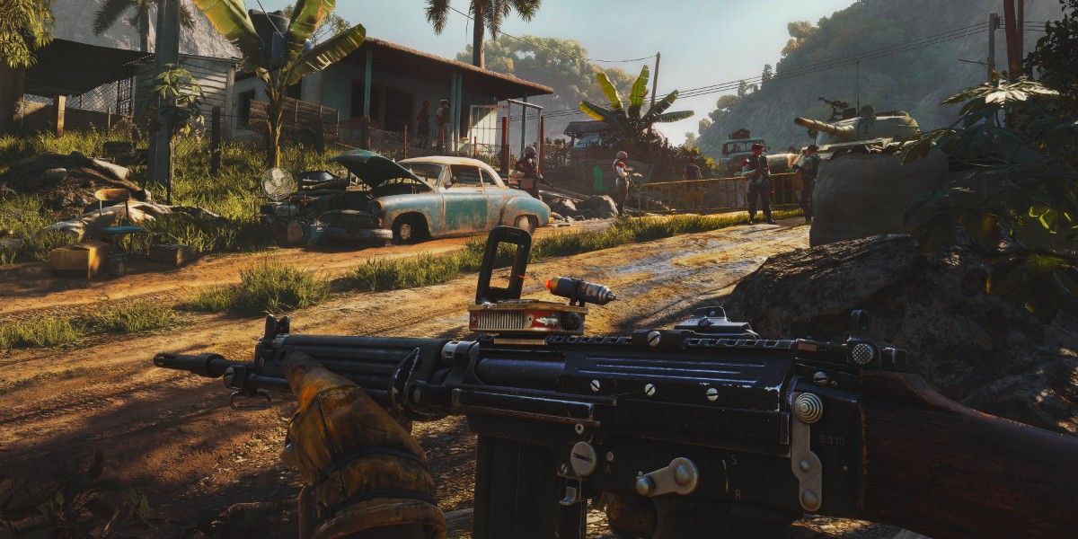 A screenshot of gameplay from Far Cry 6, featuring the player character holding a gun and walking through a ruined town