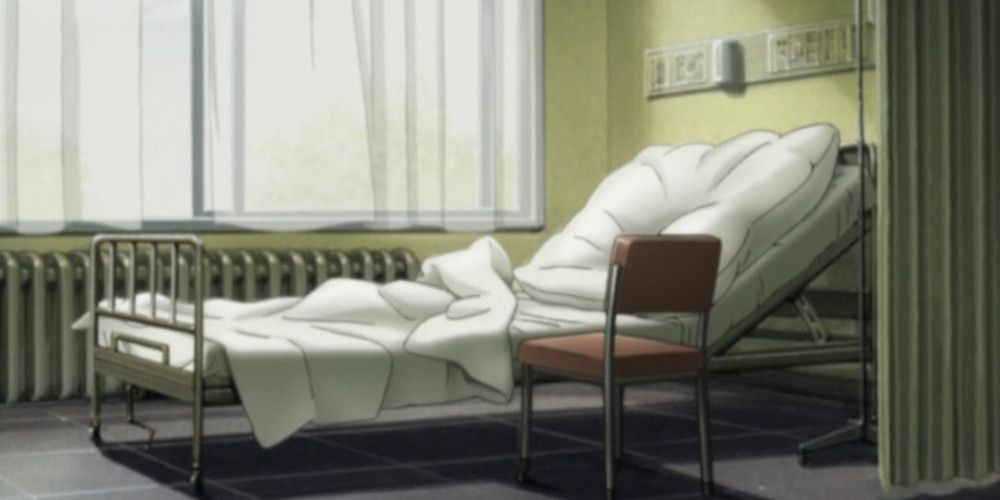 An empty hospital bed with a chair beside it in Monster