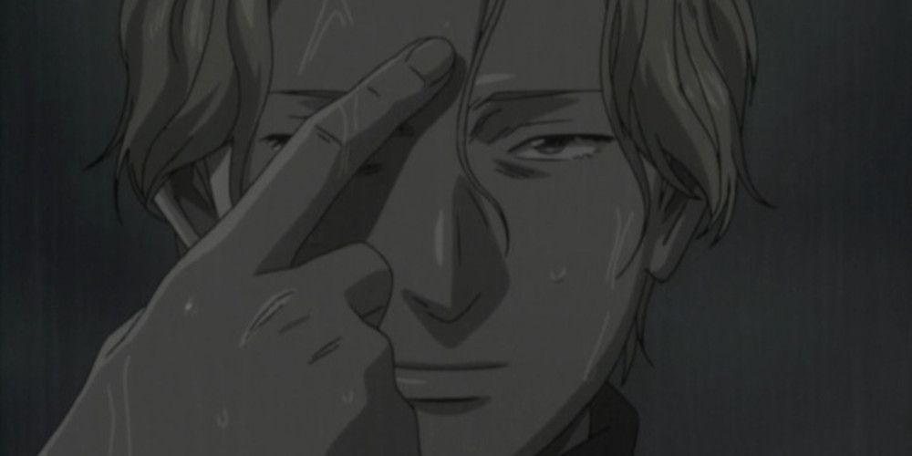 Johan Liebert pointing at his forehead in Monster.