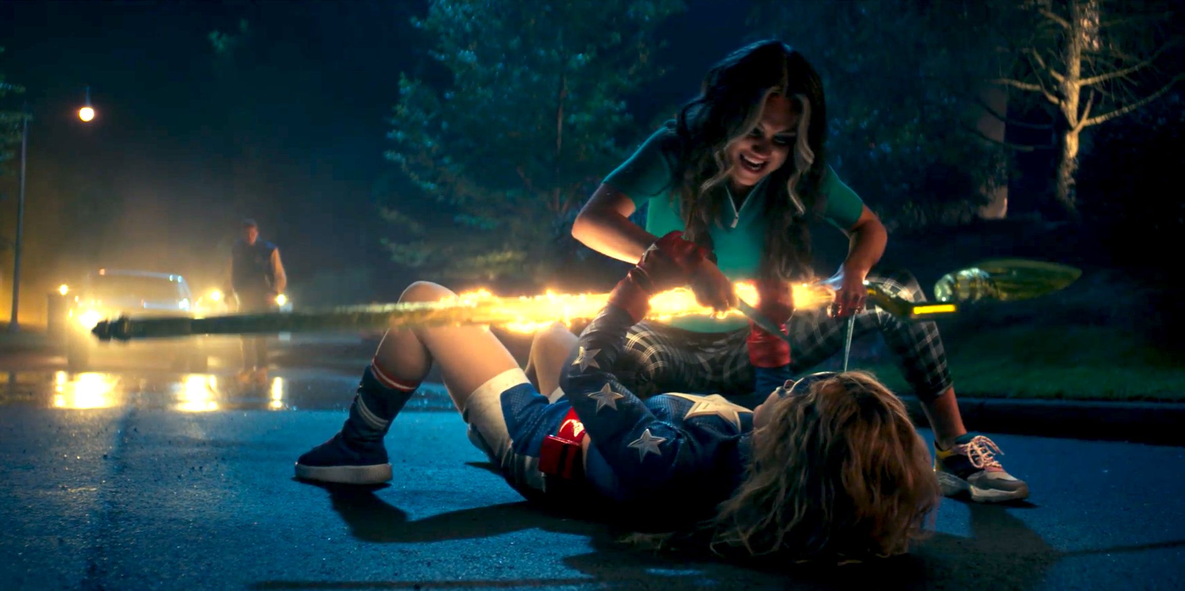 Shiv kneeling over a pinned-down Stargirl, trying to stab her.