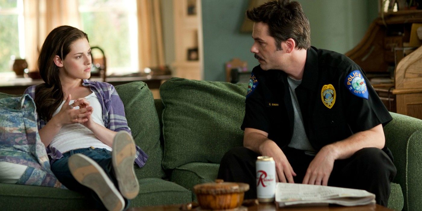Bella Swan with Charlie in Twilight sitting on a couch.