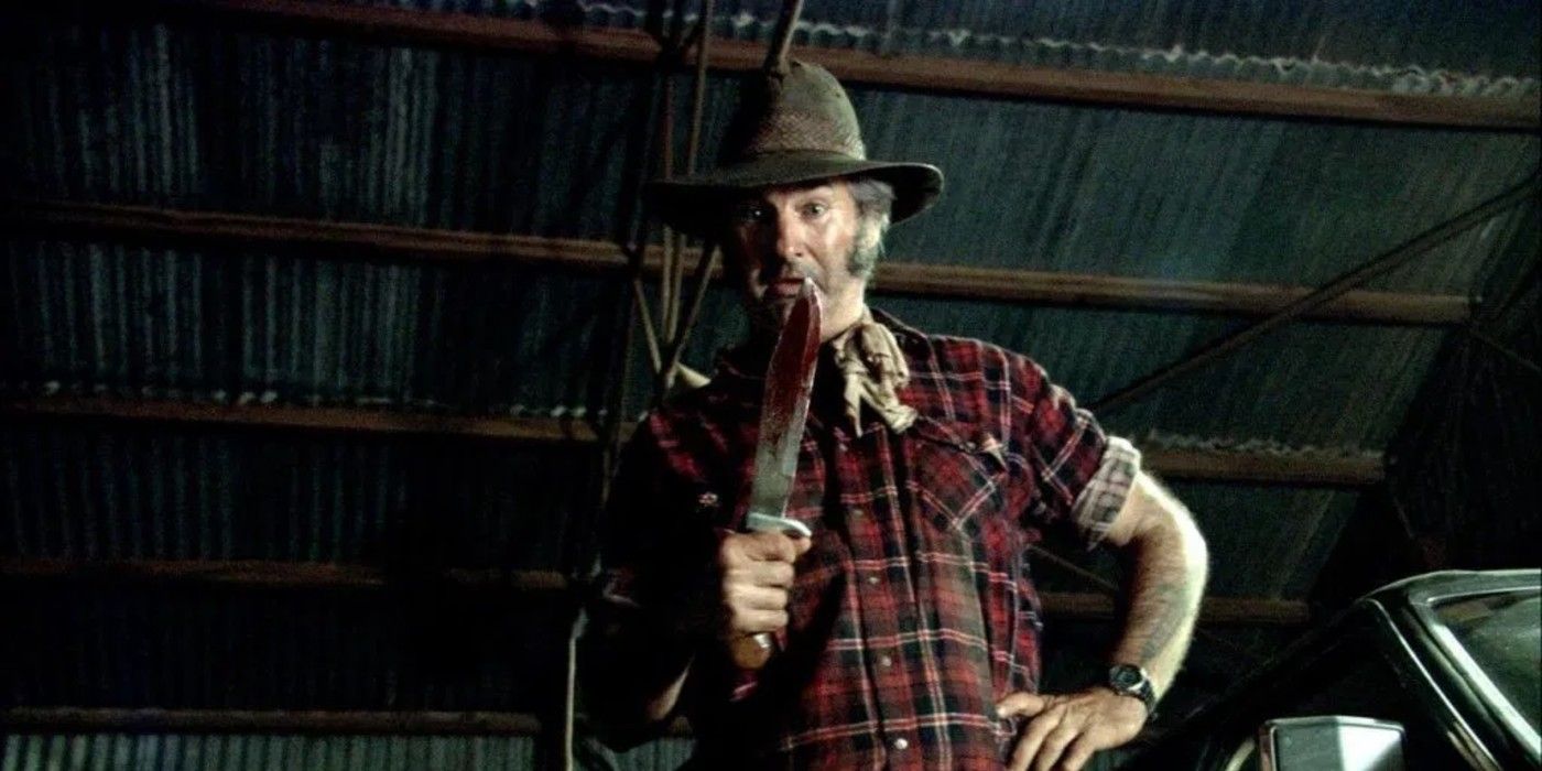 Mick Taylor holding a knife from Wolf Creek