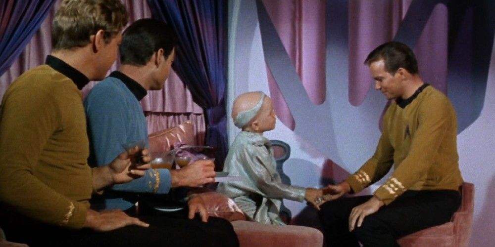 The crew of the Enterprise meeting an alien on Star Trek