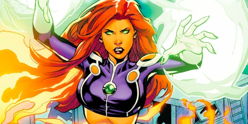 Starfire uses her powers, creating green energy around her hands in DC Comics