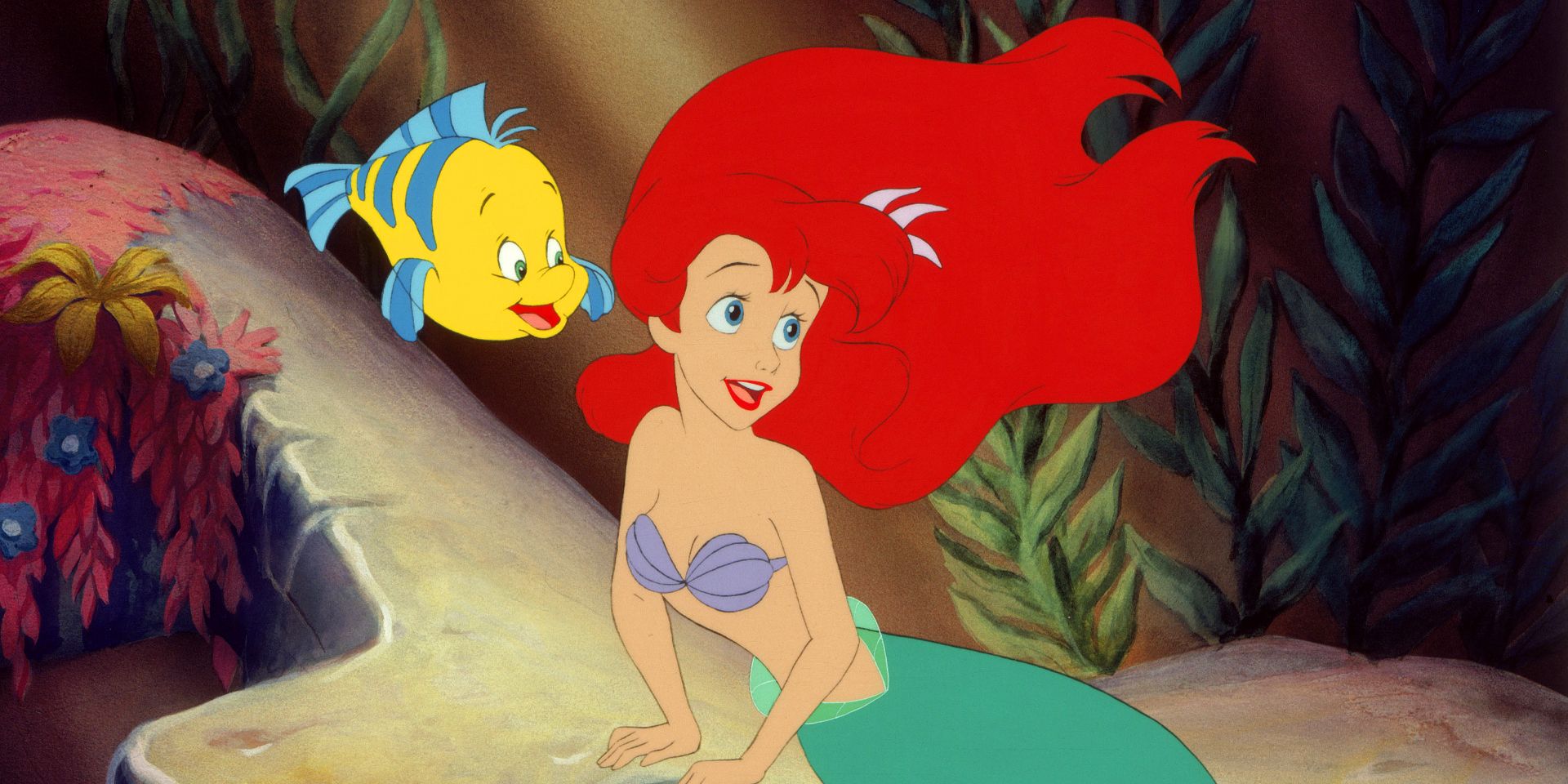 Ariel and Flounder looking on in wonder in The Little Mermaid