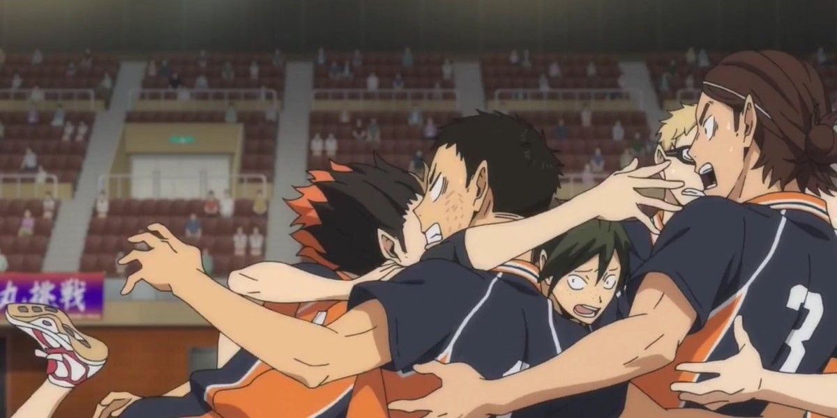 Karasuno team has a group hug on the court after a game