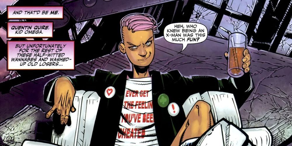 Quentin Quire sits, looking at the viewer and holding a drink