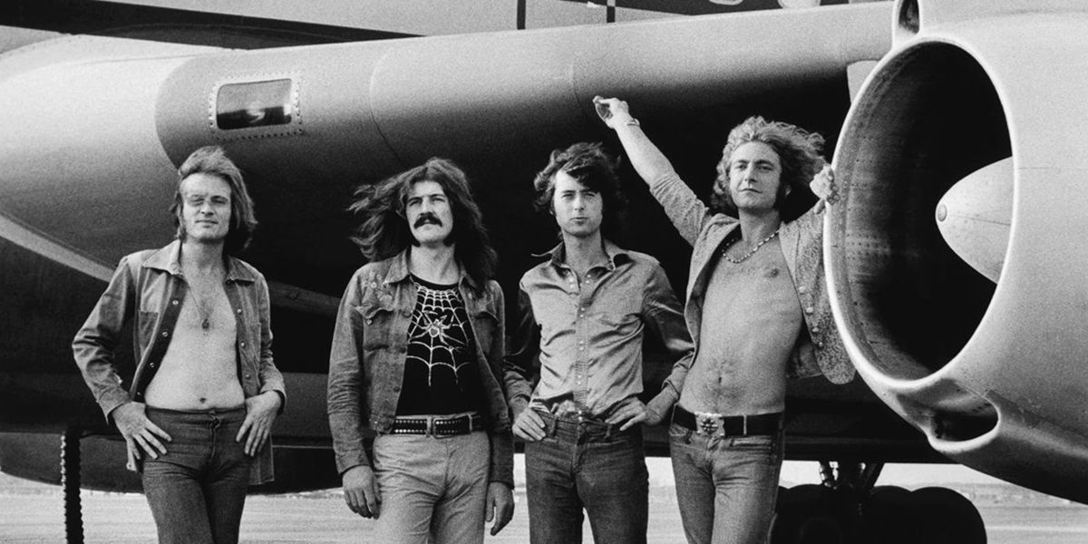 Led Zeppelin group members in front of a plane