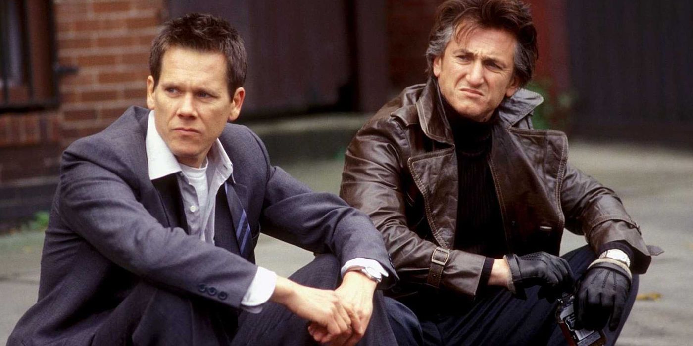 Kevin Bacon and Sean Penn sitting down in Mystic River