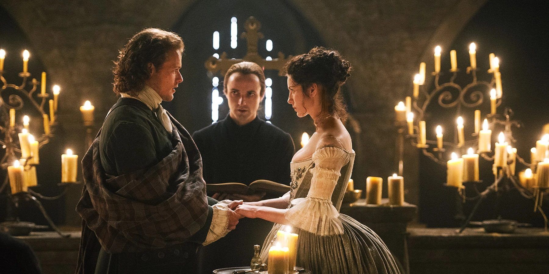 Jamie and Claire stand at the alter as they wed in Outlander