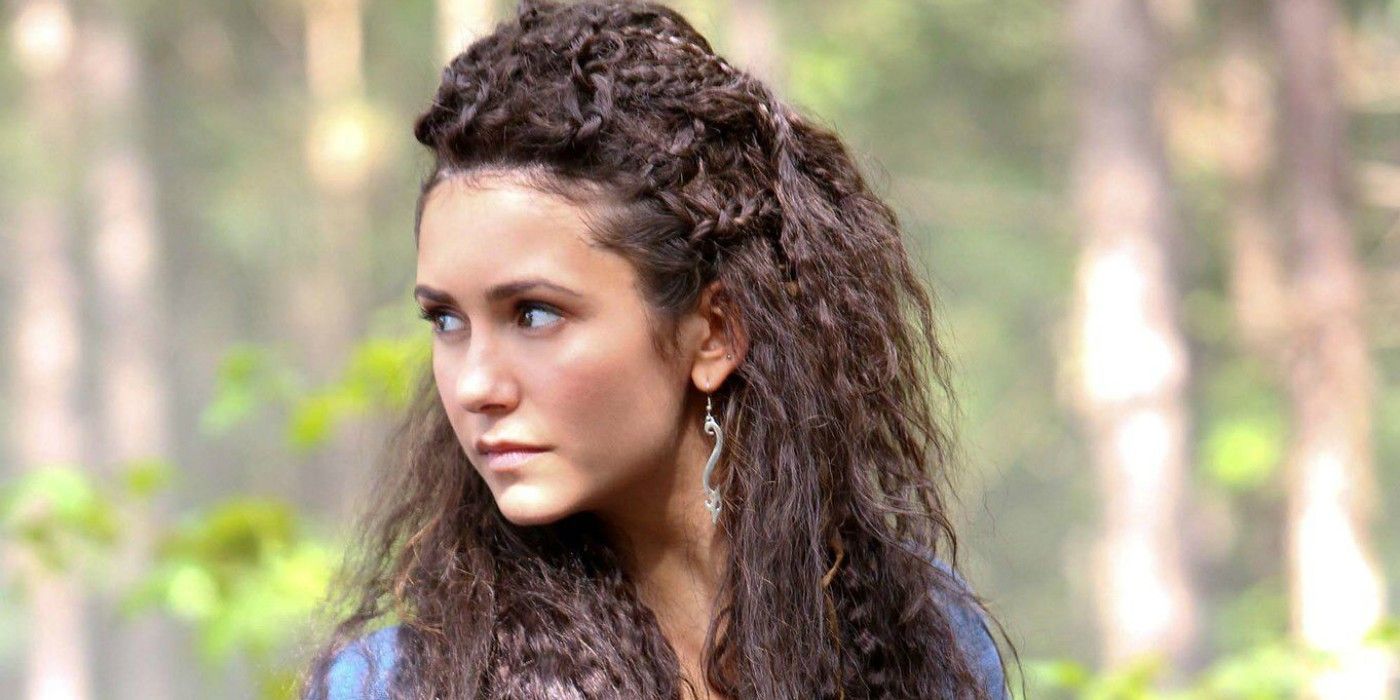 Nina Dobrev as Tatia looking back in a forest in The Vampire Diaries.