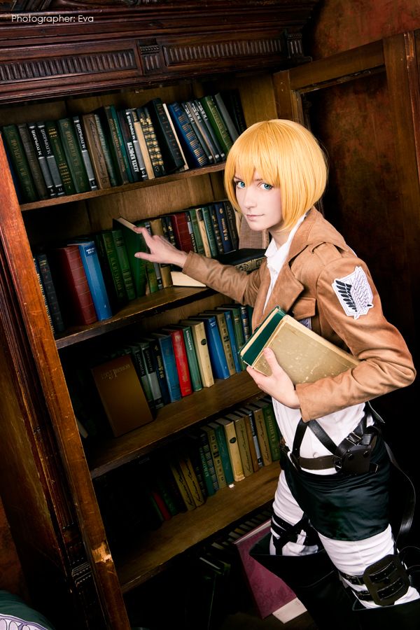 armin cosplay reading books in a library in scouts uniform.