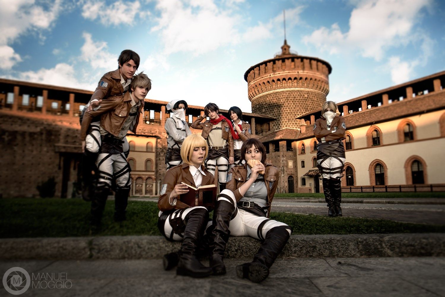 A group cosplay of Attack on Titan characters with Armin sitting at the front.