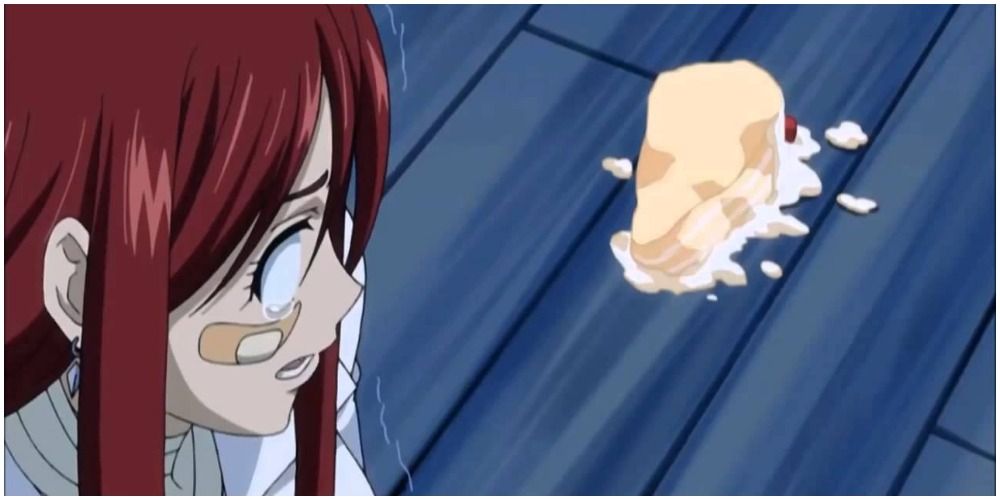 Erza Scarlet from Fairy Tail looking sadly at a piece of strawberry cake that was dropped on the floor.