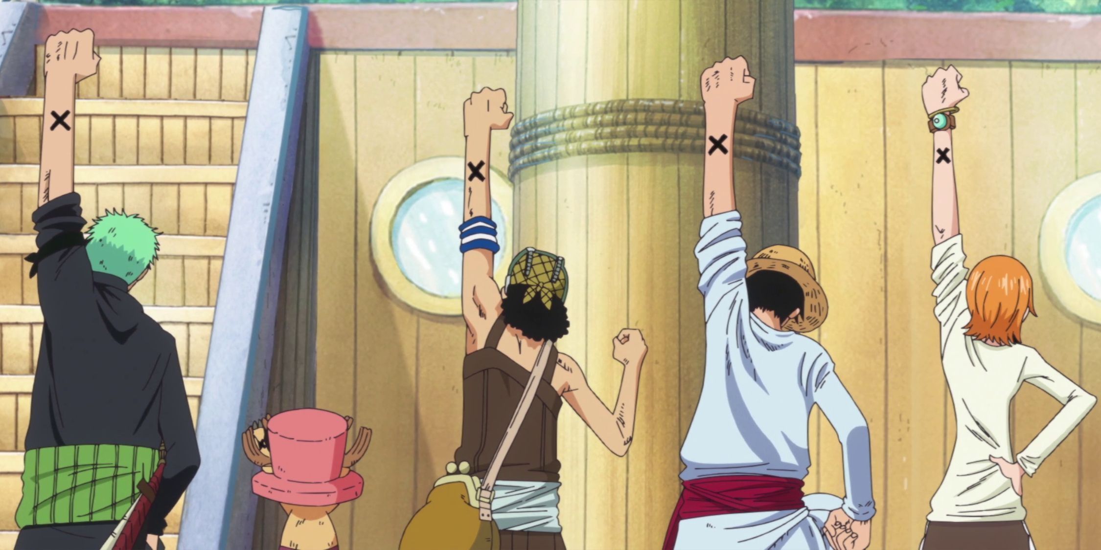 The Straw Hat Pirates pumping their fists in the air aboard their vessel