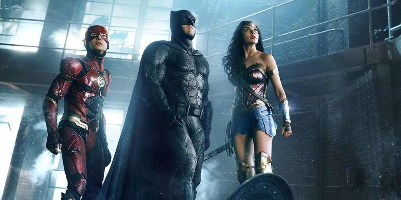 Wonder Woman, Batman, and The Flash stand together in a scene from Justice League