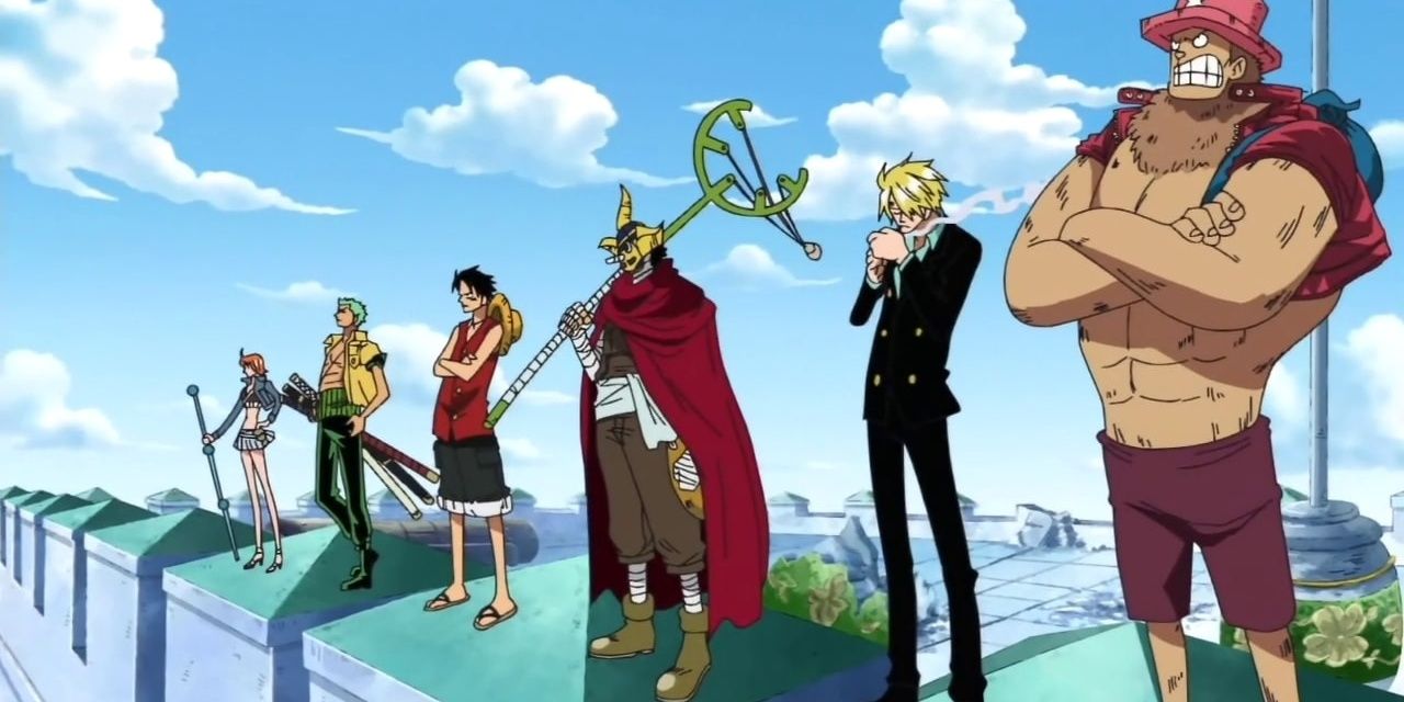 The Straw Hat Pirates standing in a row atop a battlement