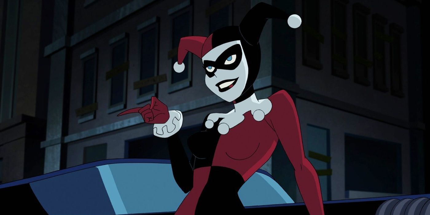 Harley Quinn leaning against the Batmobile
