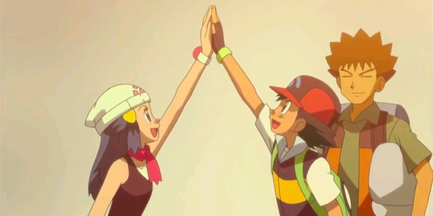 Ash Dawn highfiving with Brock in the background in Pokemon