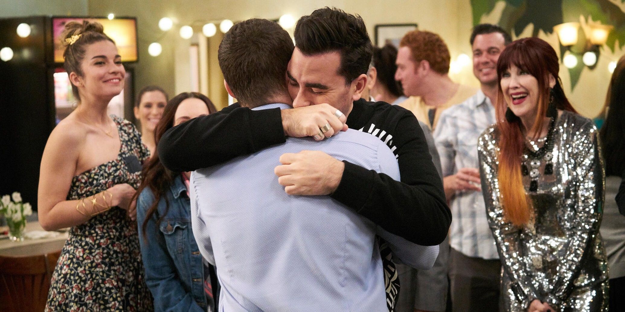 David and Patrick hugging in front of friends and family in Schitt's Creek