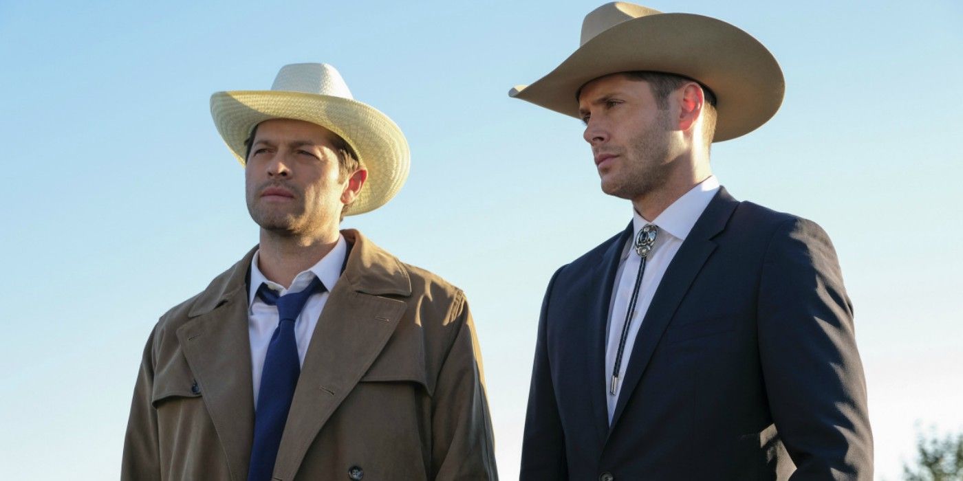 Castiel and Dean stand next to each other in cowboy hats in Supernatural 