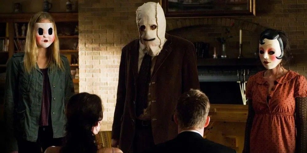 The trio of strangers invading the couple's home in The Strangers