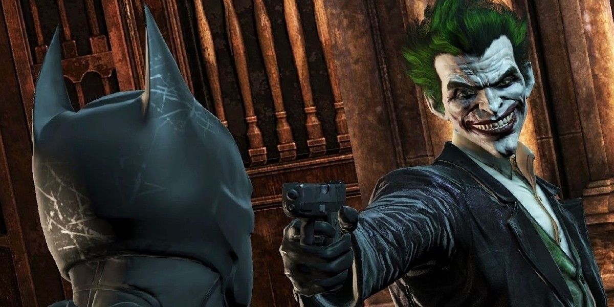 Joker pointing a gun at Batman