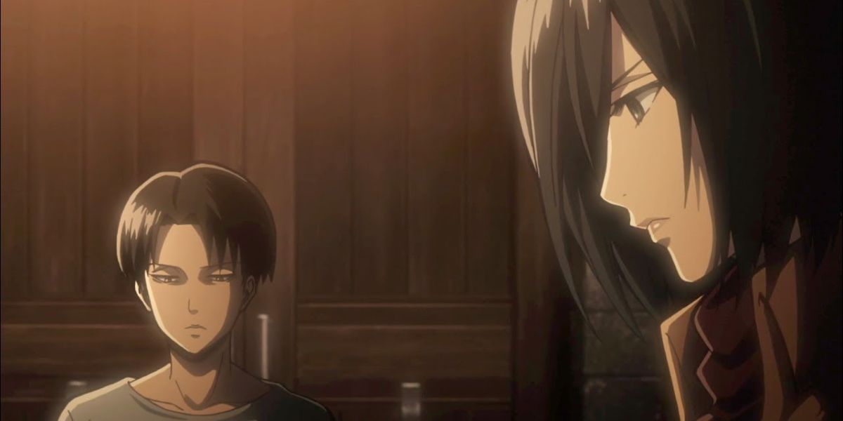 Levi and Mikasa sit stoically at a table