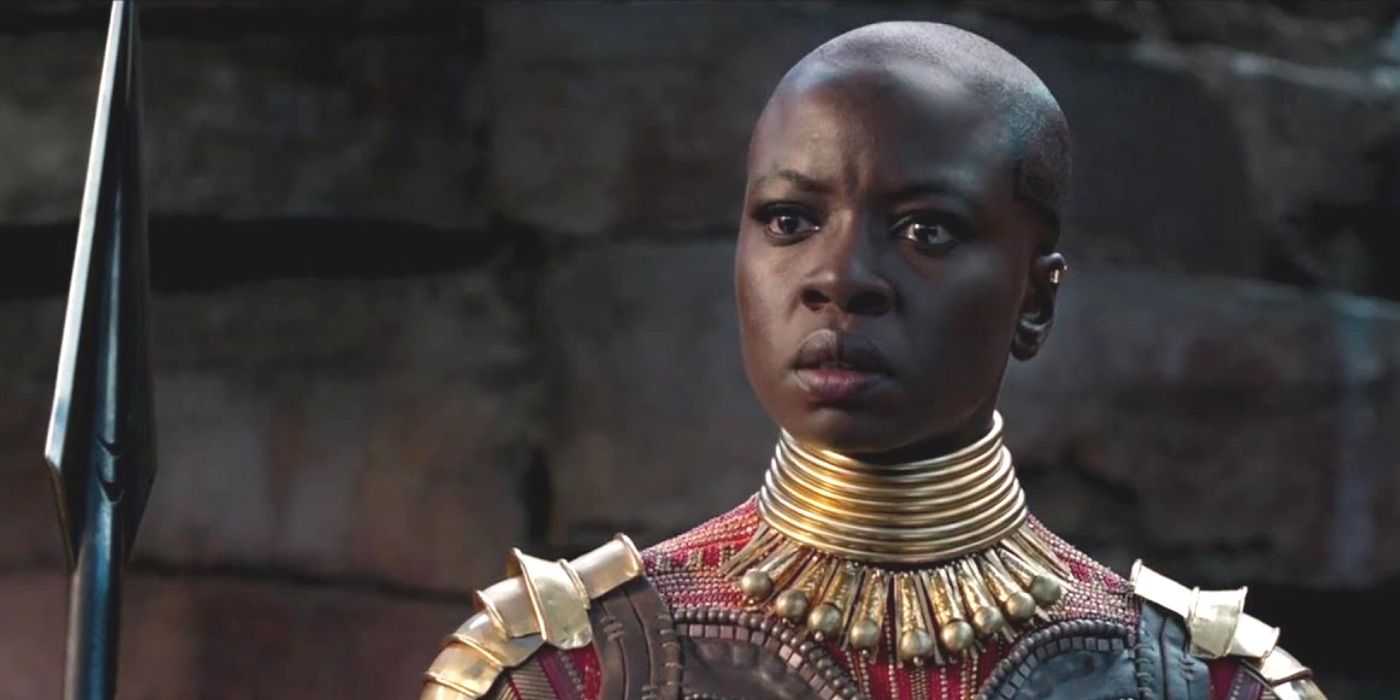 Okoye looking upset while holding her spear in Black Panther