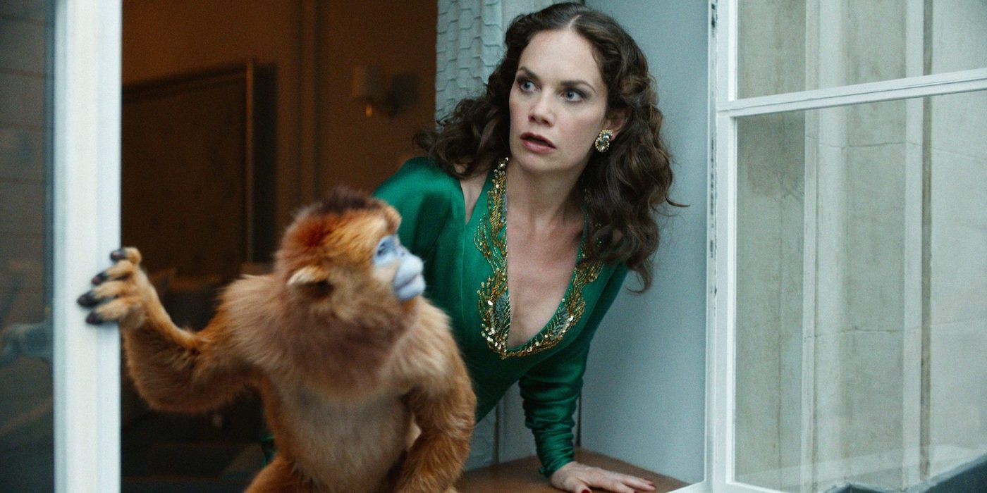 Mrs. Coulter (played by Ruth Wilson) and her daemon looking out the window for Lyra in His Dark Materials