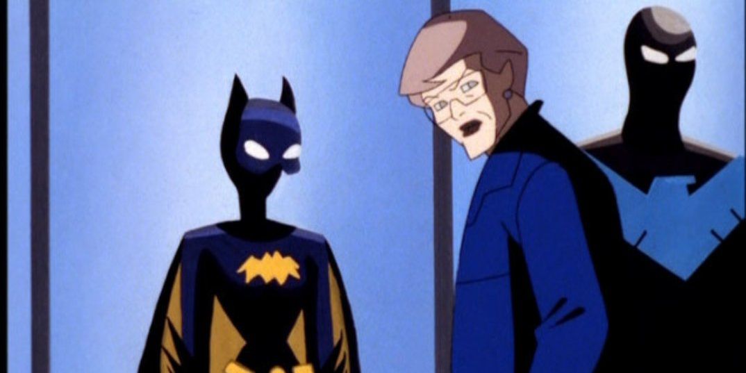 Barbara Gordon stands with her old Batgirl costume