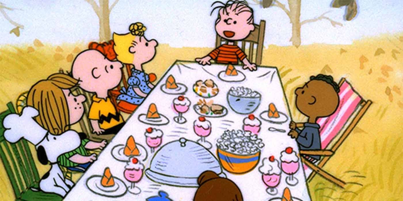 The Peanuts gang sitting around the table for Thanksgiving