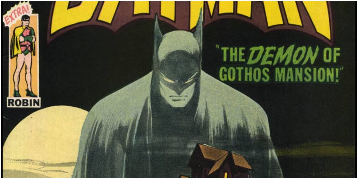 A spectral Batman looms over a haunted mansion on a DC Comics cover.