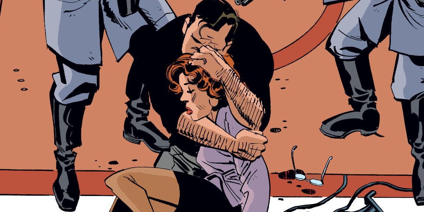 Bruce Wayne holding Vesper Fairchild's body in Bruce Wayne: Murderer?
