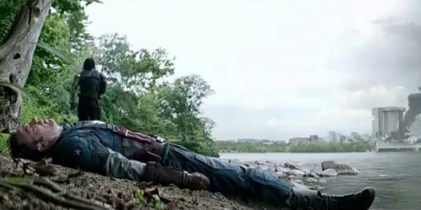 a man walks away from an unconscious man next to a river