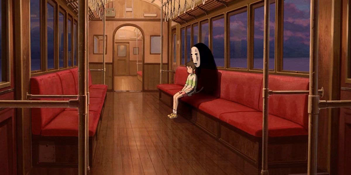 Chihiro And No-Face sit side-by-side on the empty train