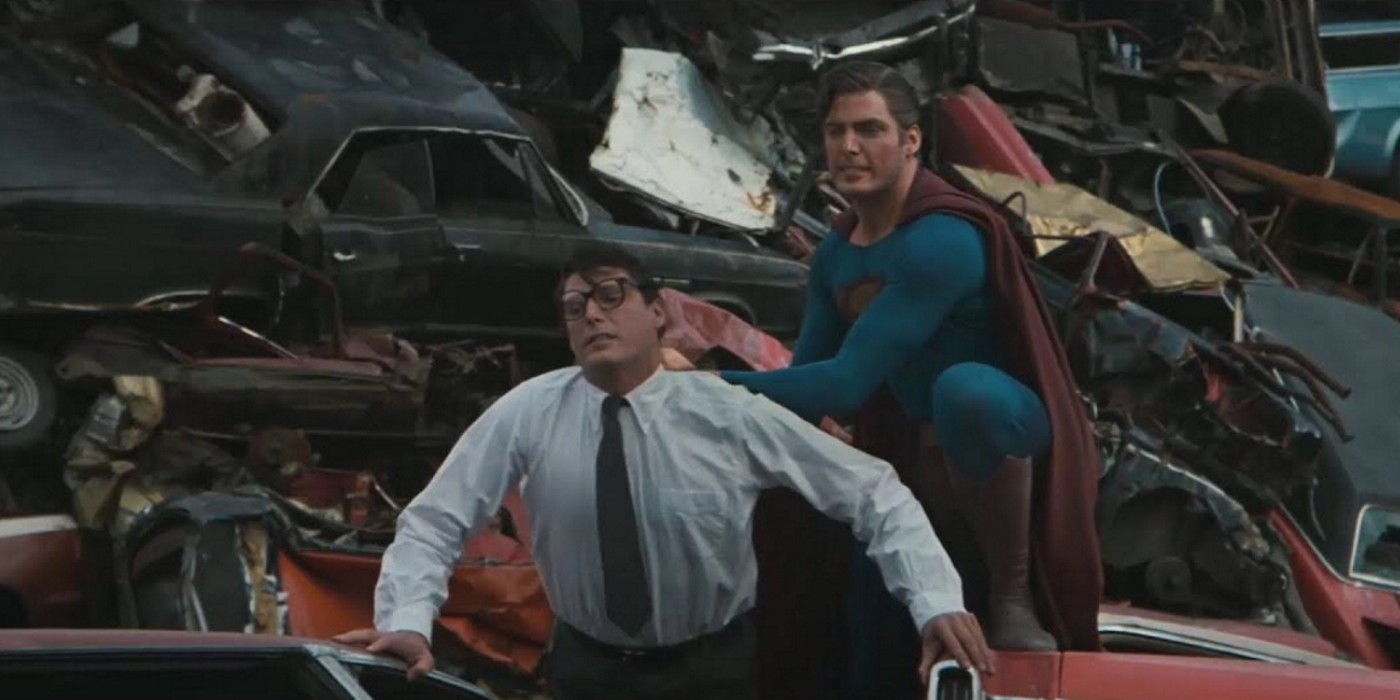 superman fighting himself, clark kent, in a junkyard filled with old cars