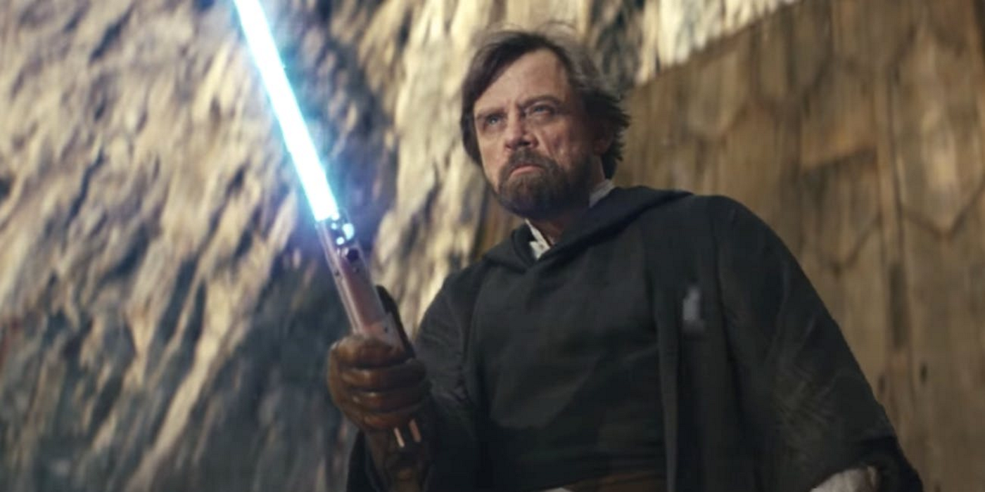 Luke Skywalker (Mark Hamill) in The Last Jedi holding his blue lightsaber