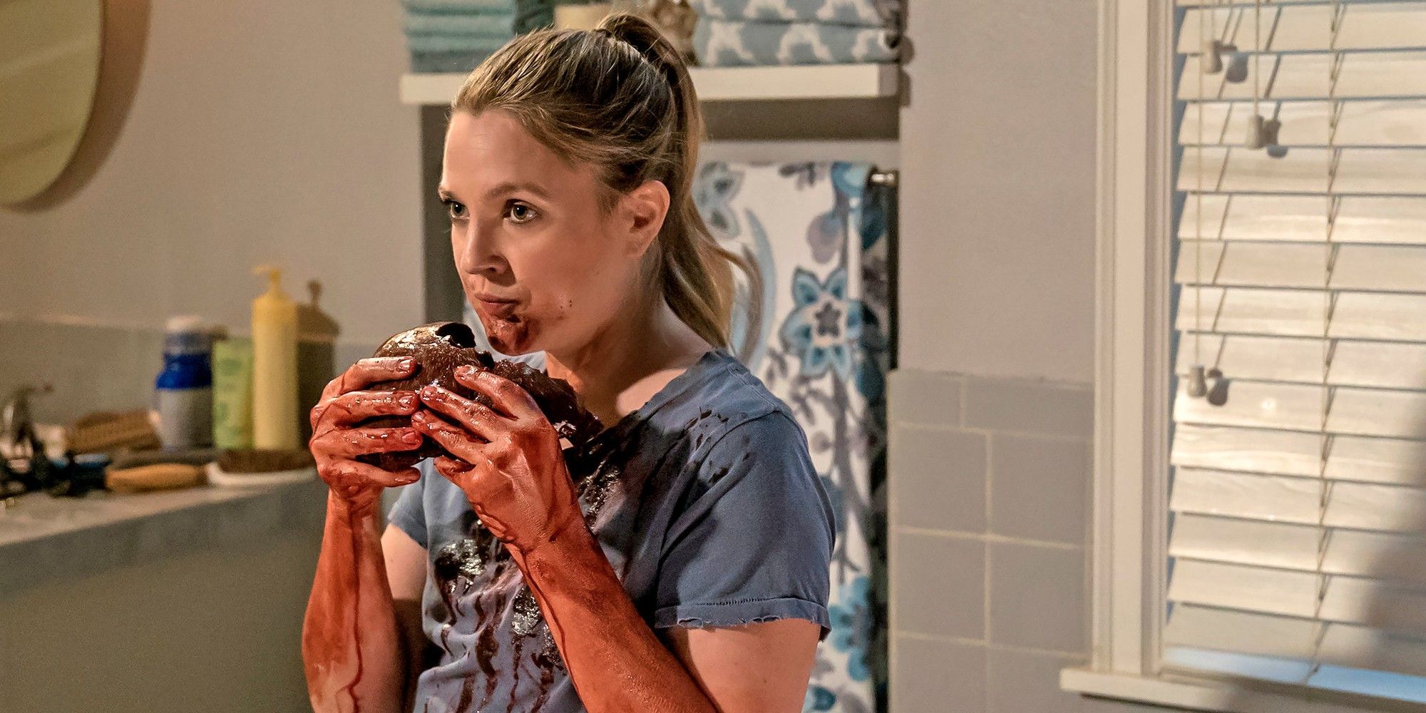 Drew Barrymore as Sheila Hammond eating one of her victims in Santa Clarita Diet 