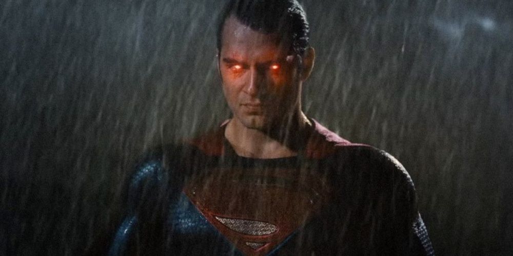 Superman in the rain with his eyes glowing red.