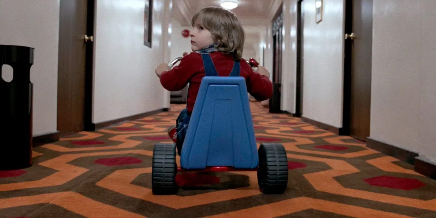 Daniel Torrance rides a tricycle in a corridor in The Shining