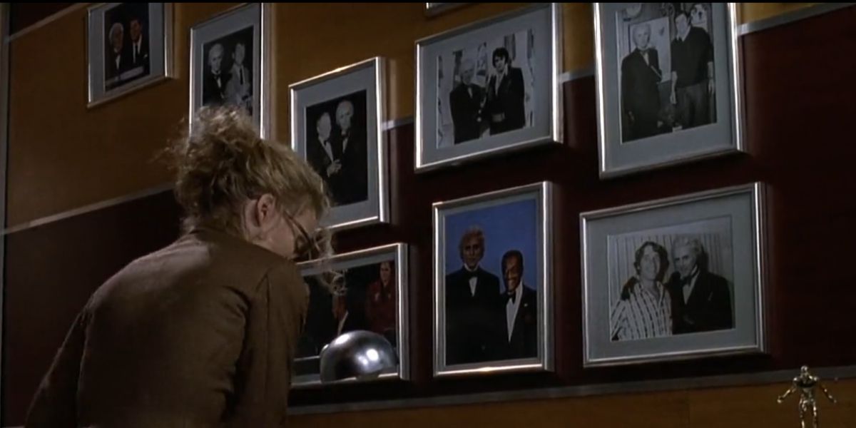 Selina stands in front of photos of Max Shreck and famous people