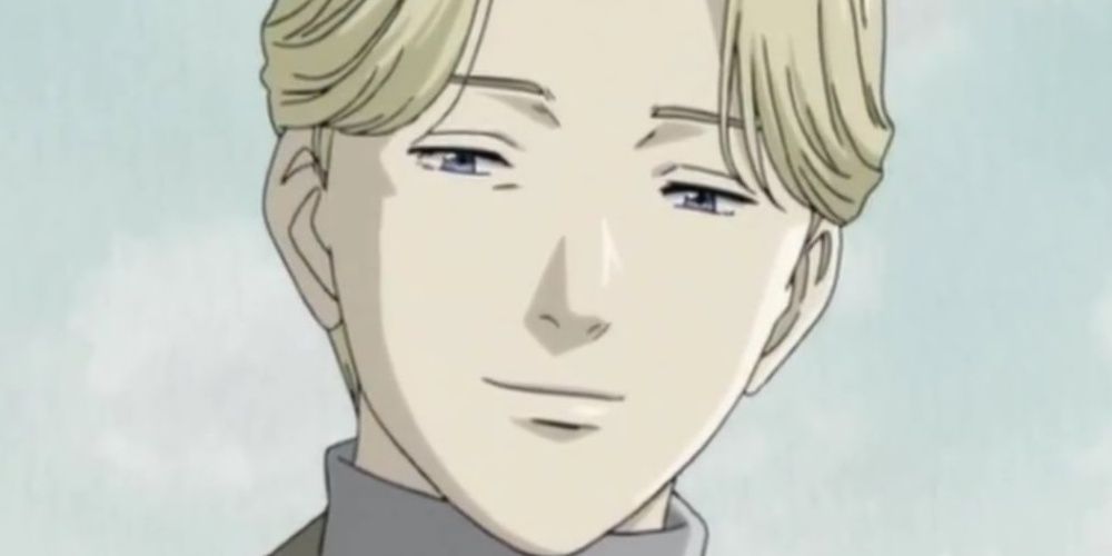 A close-up of Johan Liebert smiling in the Monster anime
